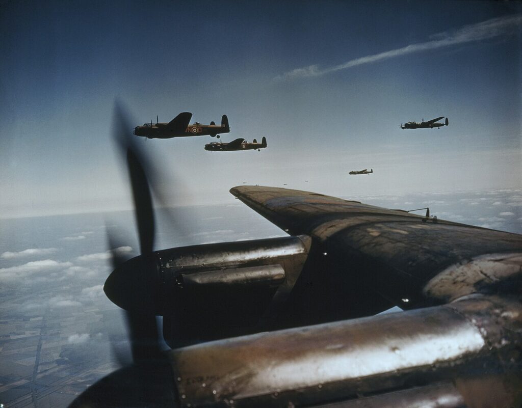 Lancaster B Mark Is of No 50 Squadron, Royal Air Force, based at Skellingthorpe, flying in spread formation. The two aircraft beyond the wing tip are 'VN-D' and 'VN-J' the former, serial number JA899, was missing on the night of 24 - 25 June 1944 with Pilot Officer L G Peters and crew.
