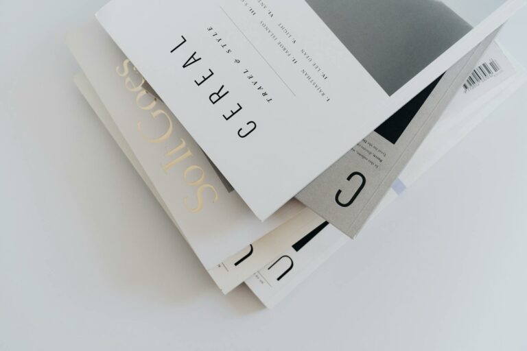 Aesthetic stack of minimalist travel and style magazines with elegant typography.